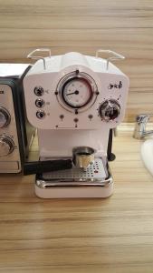 a white espresso machine sitting on top of a table at Feel Sofia - one bedroom apartment next to Russian Square in Sofia