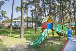 a playground with a slide in a park at Pomorze Ustka in Ustka