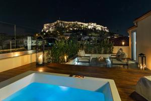 a large swimming pool with a balcony overlooking the ocean at A77 Suites by Andronis in Athens