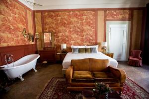 a bedroom with a bed and a bath tub and a bed and a couch at Oltrarno Splendid in Florence