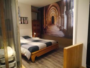 a bedroom with a bed and a painting on the wall at Campana in Avignon +10 photos