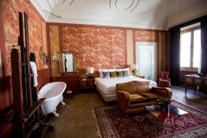 a hotel room with a bed and a bath tub and a tub at Oltrarno Splendid in Florence