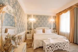 a bedroom with a large bed and two tables at Hotel Aivani Old Tbilisi in Tbilisi City