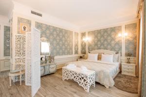 a bedroom with a large bed and a table at Hotel Aivani Old Tbilisi in Tbilisi City