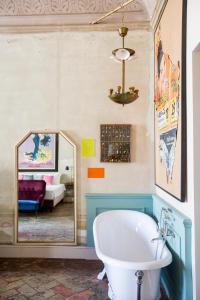 a bathroom with a bath tub and a mirror at Oltrarno Splendid in Florence