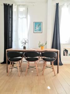 a dining room table with two chairs around it at Beautiful family flat nearby the Flea Market, Stade de France, Montmartre in Saint-Ouen