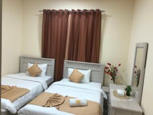 Кровать или кровати в номере Al Khaleej Plaza Furnished Apartments LLC