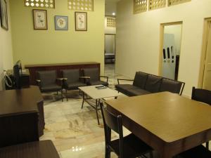 a waiting area with tables and chairs in a waiting room at Vynn's @ Banda Kaba in Melaka