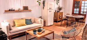 a living room with a couch and a table at Beach Tree House in Porto Santo +11 photos