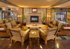 a living room with couches and a table and a fireplace at Inn of the Governors in Santa Fe