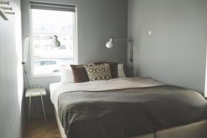 a bedroom with a large bed with a window at Saga Studios by Heimaleiga in Reykjavík