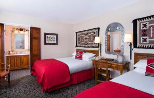 a hotel room with a bed, desk, and chair at Inn of the Governors in Santa Fe