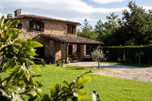 - Vistas al exterior de una casa de piedra con jardín en Casale Nasca, en Castelraimondo