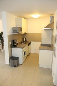 a small kitchen with a stove and a microwave at 4realax in Mülheim an der Ruhr