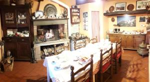 a dining room with a table and a fireplace at B&B La Margine e SPA in Cocciglia