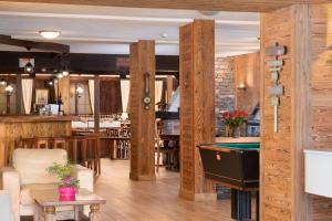 un restaurante con mesa de billar en una habitación en Hotel La Prairie en Crans-Montana