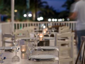 a table with wine glasses and candles on a balcony at Ariadne Hotel in Platanes +30 photos