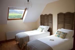 A bed or beds in a room at Madra Rua Organic Accommodation