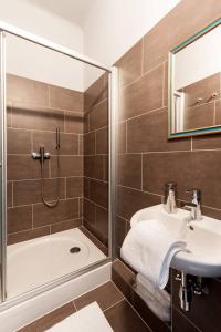 a bathroom with a shower and a sink and a tub at Europe Heart Apartment for 9 in Budapest
