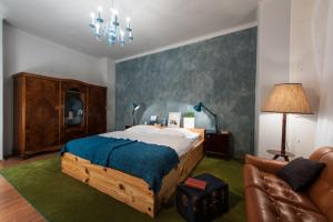 a bedroom with a large bed and a couch at Europe Heart Apartment for 9 in Budapest