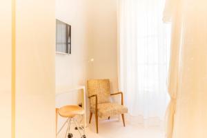 a room with a chair and a desk and a window at Fonda Llabres Boutique in Alcudia