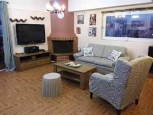 a living room with a couch and a tv at Gazi view apartments in Athens