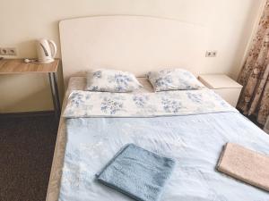 a bedroom with two beds with blue and white sheets at Complex Uspenka in Odintsovo