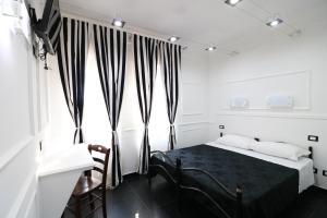 a bedroom with a bed and a window at Palace Rome in Rome