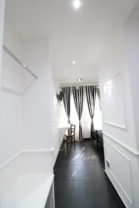 a hallway with a room with a table and chairs at Palace Rome in Rome