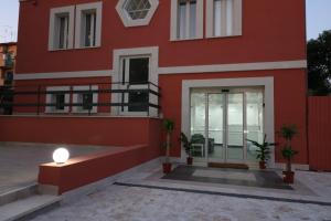a red house with a light on the side of it at Palace Rome in Rome