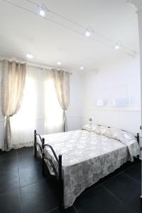 a bedroom with a bed and two windows at Palace Rome in Rome