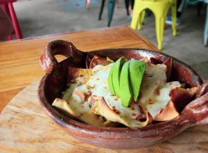 a bowl of food sitting on a wooden table at Tendo Glamping in Tepoztlán