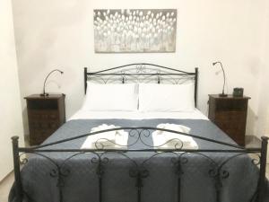 a bedroom with a black bed with two night stands at Casa di Chiara in Polignano a Mare