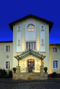 a large white building with a clock on it at Hotel Xtra Gleis in Hörstel