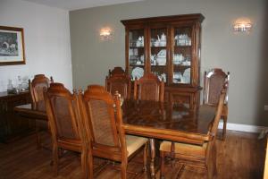a dining room with a wooden table and chairs at Labbadax House in Wisbech