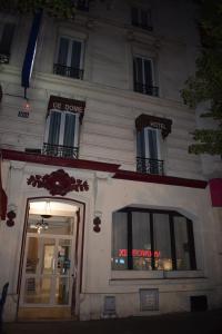 a white building with a sign on the front of it at Hotel Puy De Dôme in Paris