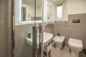 a bathroom with a toilet and a sink at QAL'AT Apart Hotel in Caltanissetta