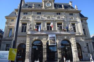 a building with a clock tower on top of it at Hotel Puy De Dôme in Paris