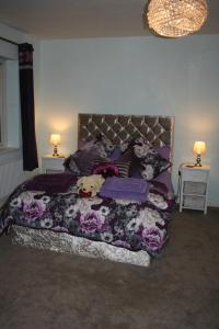 a bedroom with a bed with a stuffed animal on it at Labbadax House in Wisbech