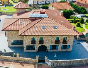 an aerial view of a house with a tile roof at Hotel Gastronómico Torre de Galizano in Galizano