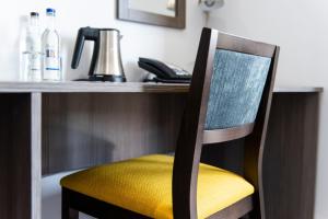 a chair sitting at a desk with a telephone at Belmont Llandudno in Llandudno