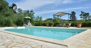 a swimming pool in a yard with a gazebo at Villa Buonaparte in San Miniato