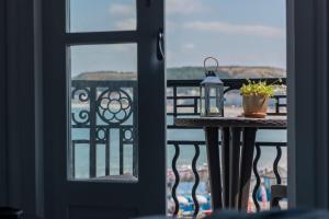 a balcony with a table and a view of the ocean at Belmont Llandudno in Llandudno