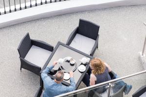 a man and a woman sitting at a table at Belmont Llandudno in Llandudno