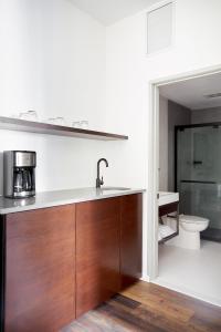 uma cozinha com um lavatório e um WC num quarto em Sonder The Queen em Filadélfia