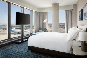 a hotel room with a large bed and a large window at Grand Hyatt at SFO in Millbrae