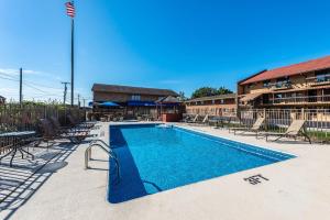 a large swimming pool with chairs and a building at Americas Best Value Inn St. Marys in Saint Marys