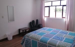 a bedroom with a bed and a window at Charlies Place in Sucre +22 photos