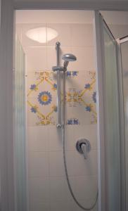 a shower in a bathroom with a tile wall at La rumba in Naples