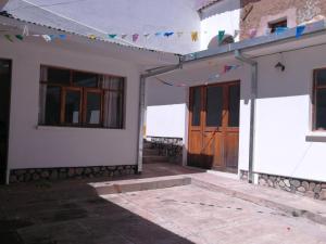 a building with a door and a string of flags at Charlies Place in Sucre